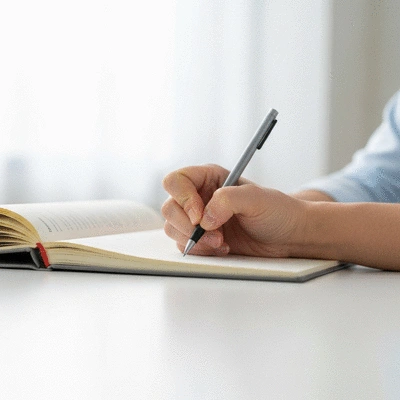 Leukemia patient writing in a symptom diary, clean and bright setting